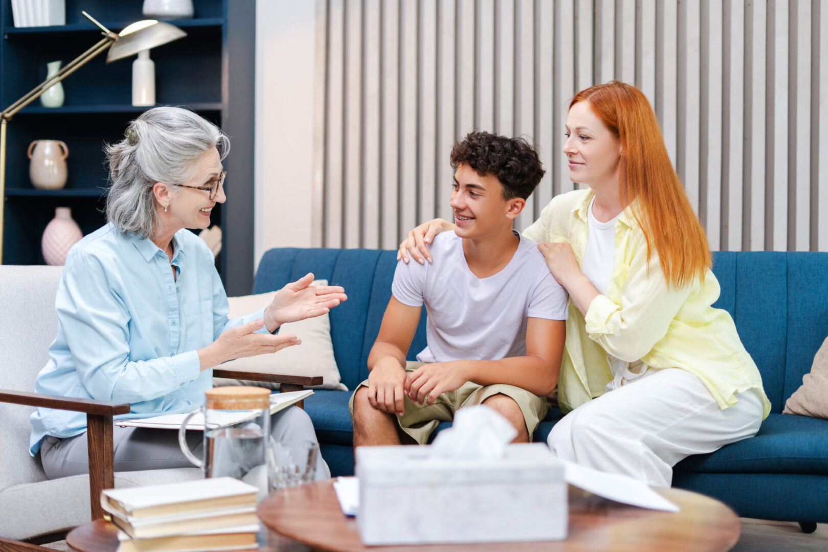 Therapist talking with family on sofa