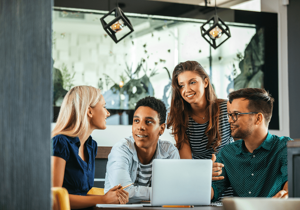 Group collaborating around a laptop