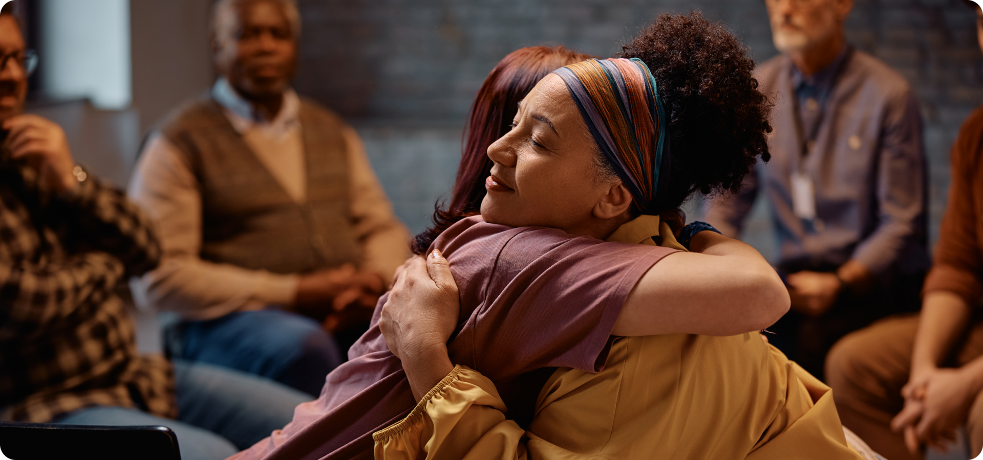 People hugging during a support group meeting.