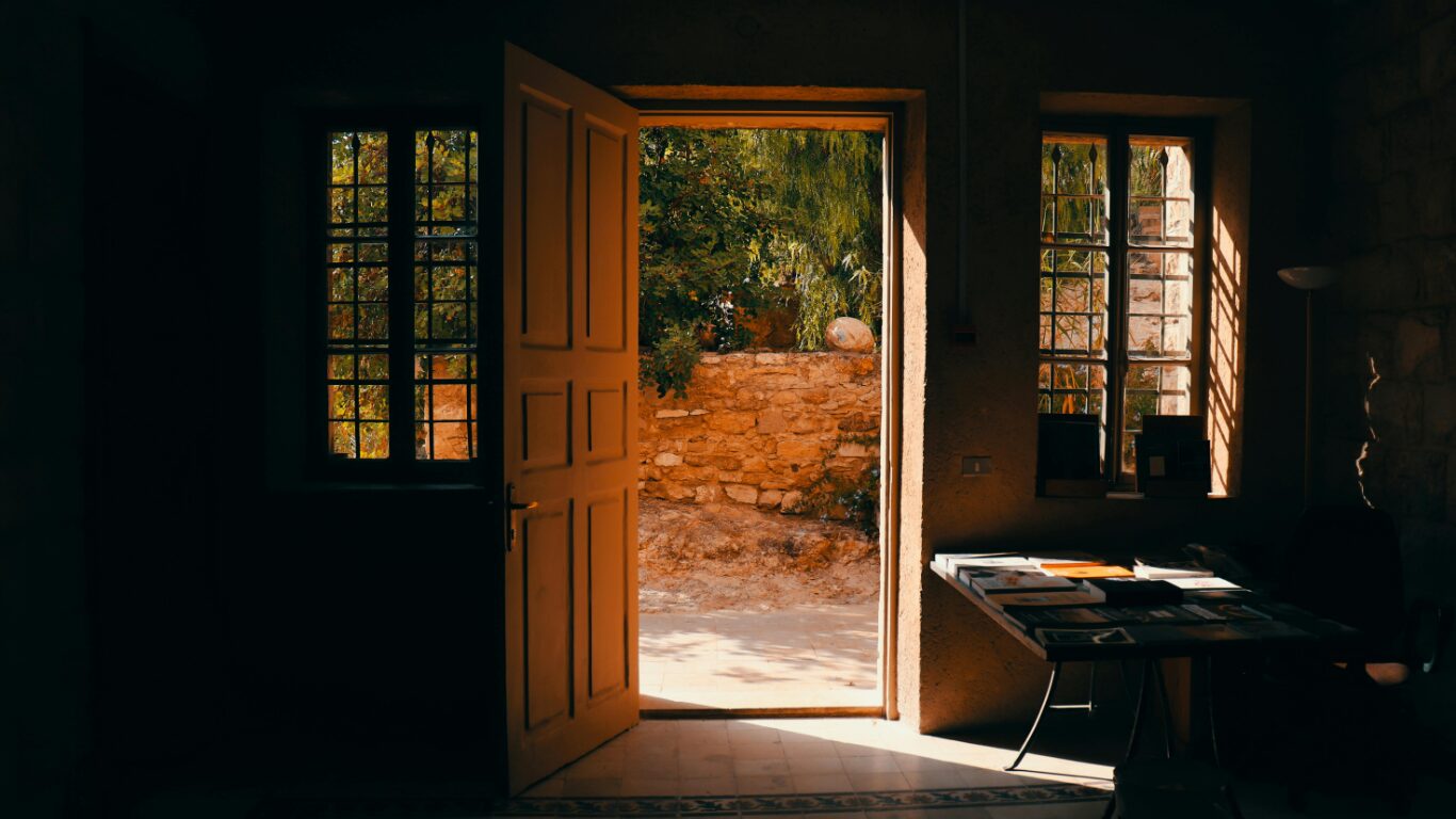 Sunlit courtyard visible through open doorway