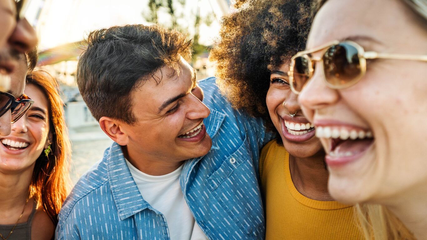 Group of diverse friends laughing outdoors