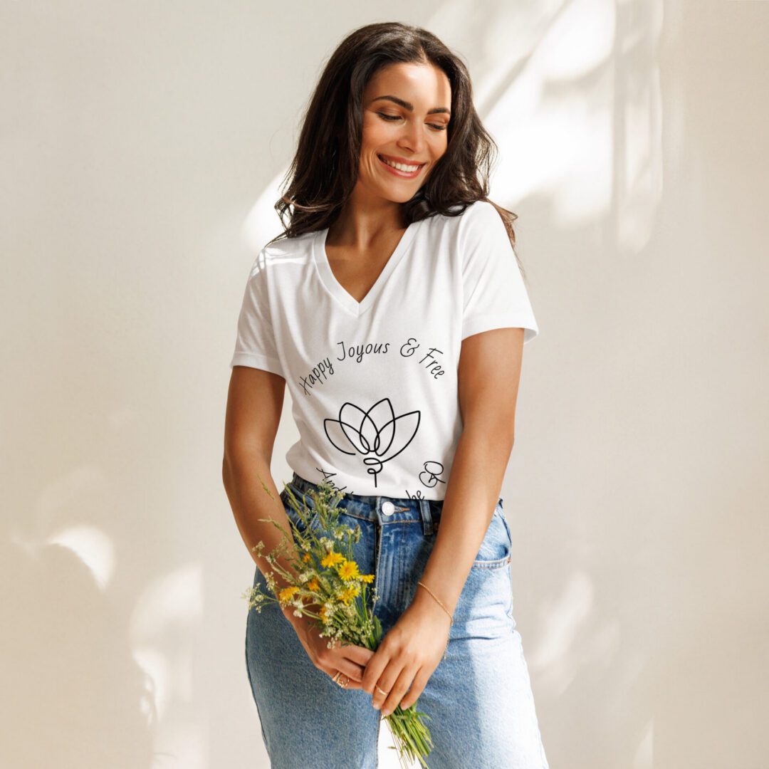 Smiling woman in white t-shirt holding wildflowers