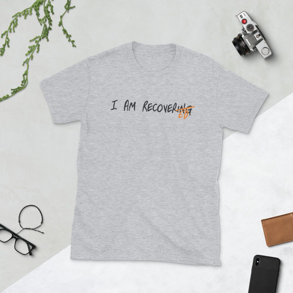 Light gray T-shirt with "I am recovering" text