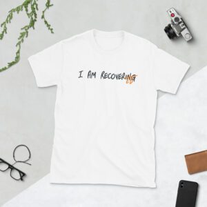 White t-shirt saying "I AM RECOVERING