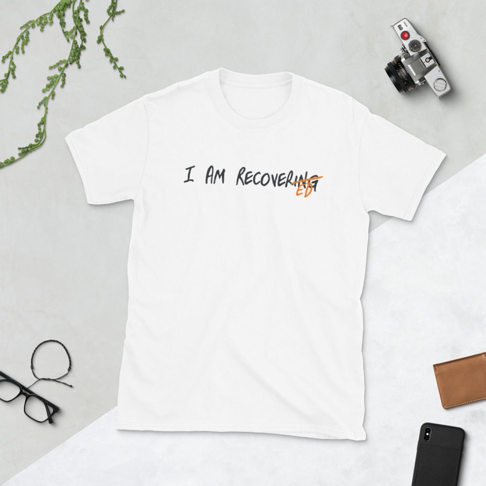 White t-shirt saying "I AM RECOVERING